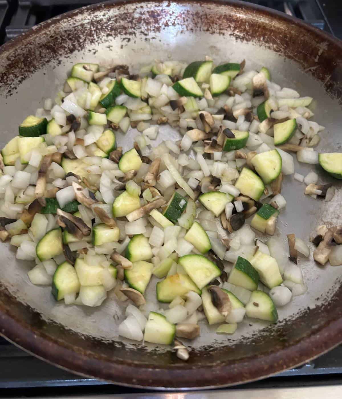 Veggies cooking in skillet.