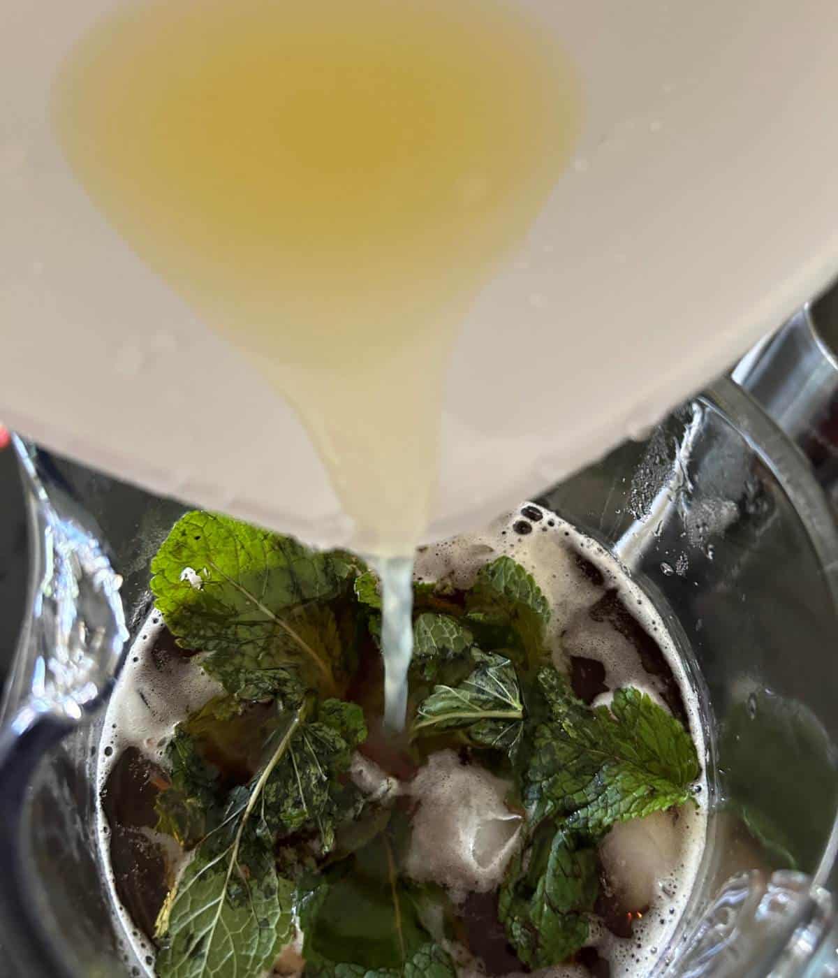 Pouring lemon juice into pitcher.