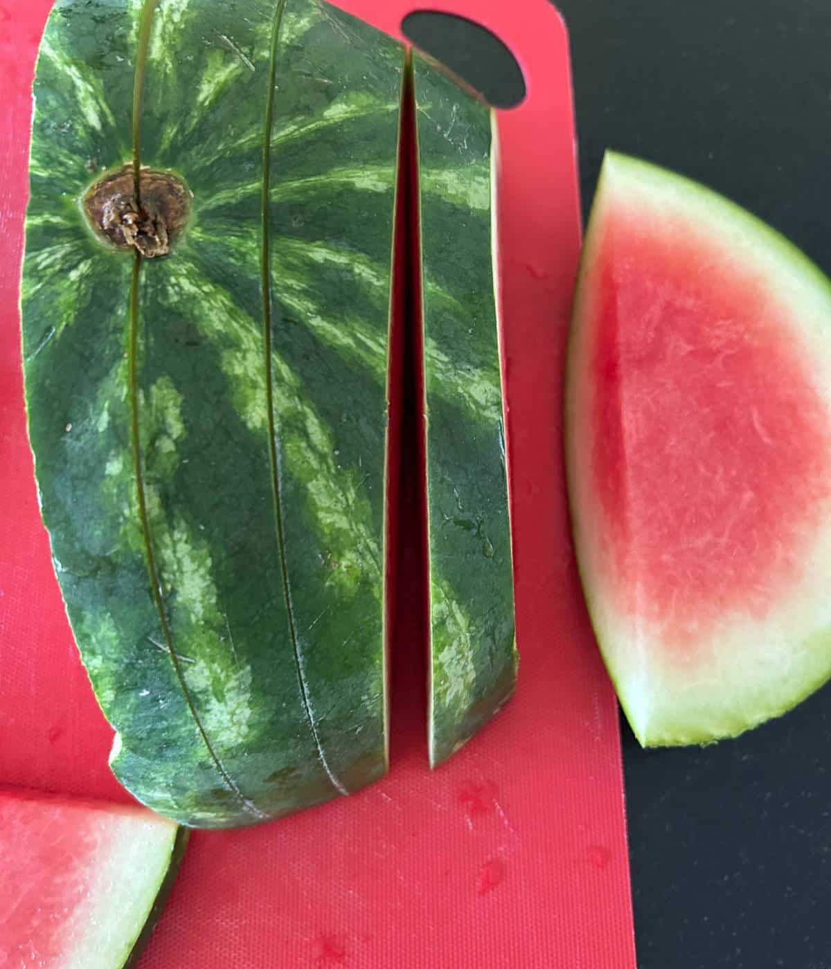 Sliced watermelon on cutting board.