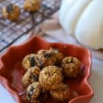 Pumpkin protein bites stacked in leaf dish.