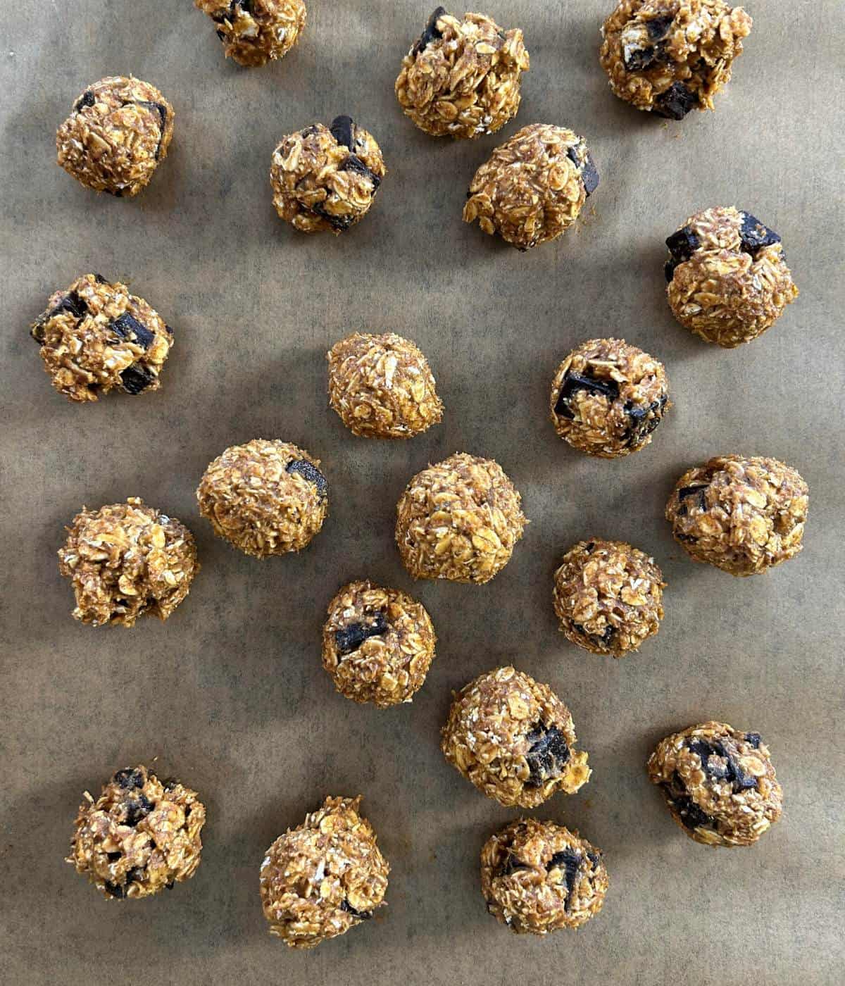 Protein balls on parchment lined baking rack.