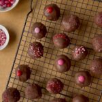 Chocolate dipped Oreo truffles on baking rack.
