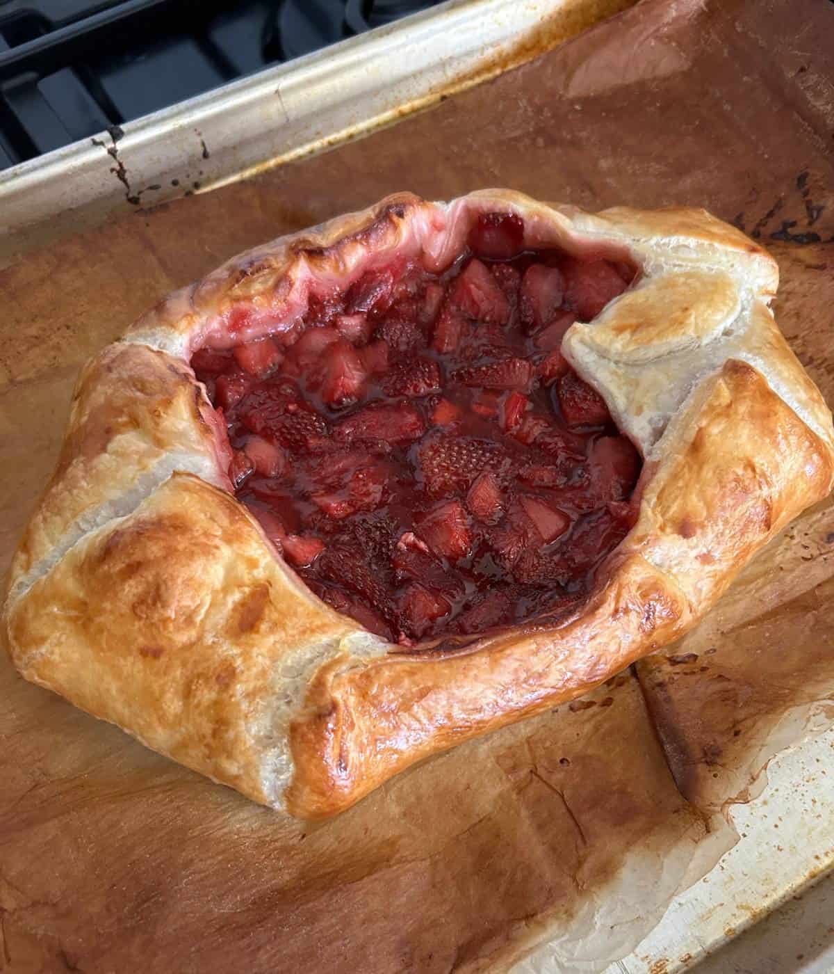 Baked puff pastry on parchment paper.
