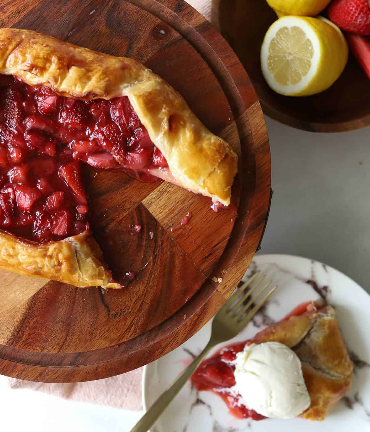 Strawberry rhubarb galette on cake plate.