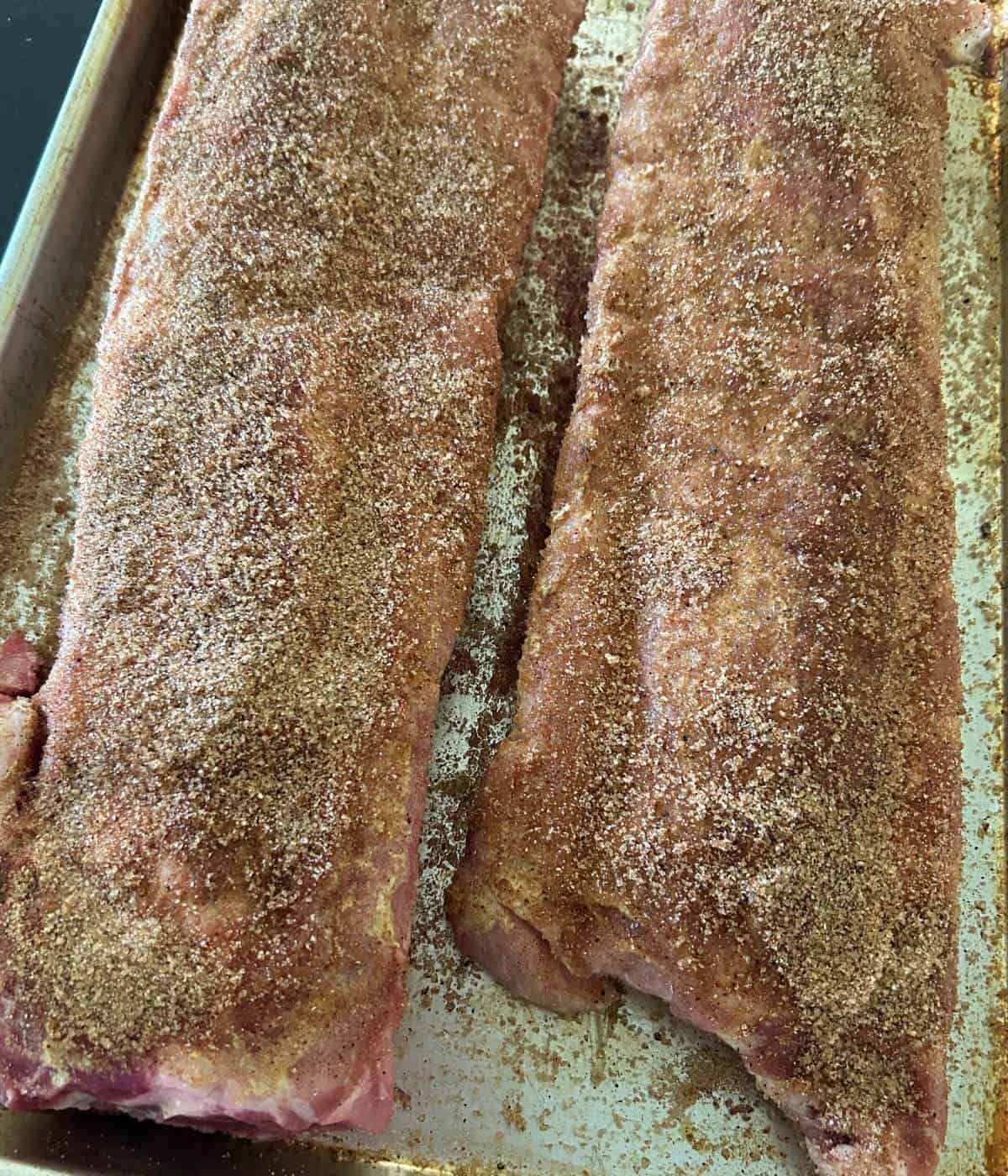 Dry rub on baby back ribs.