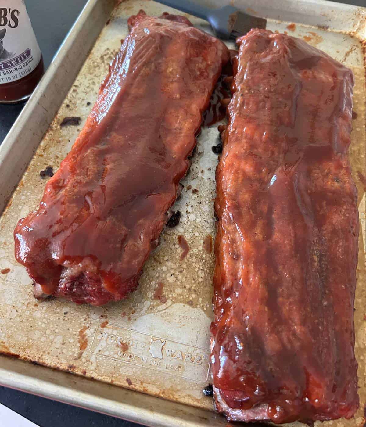 Saucy ribs on cutting board.