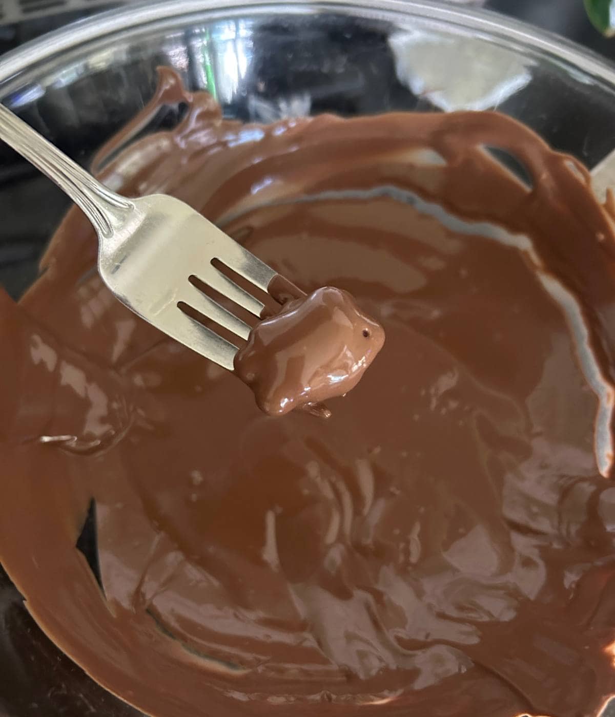 Dunking Teddy grahams in chocolate.