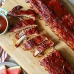 Smoked bbq baby back ribs on cutting board.