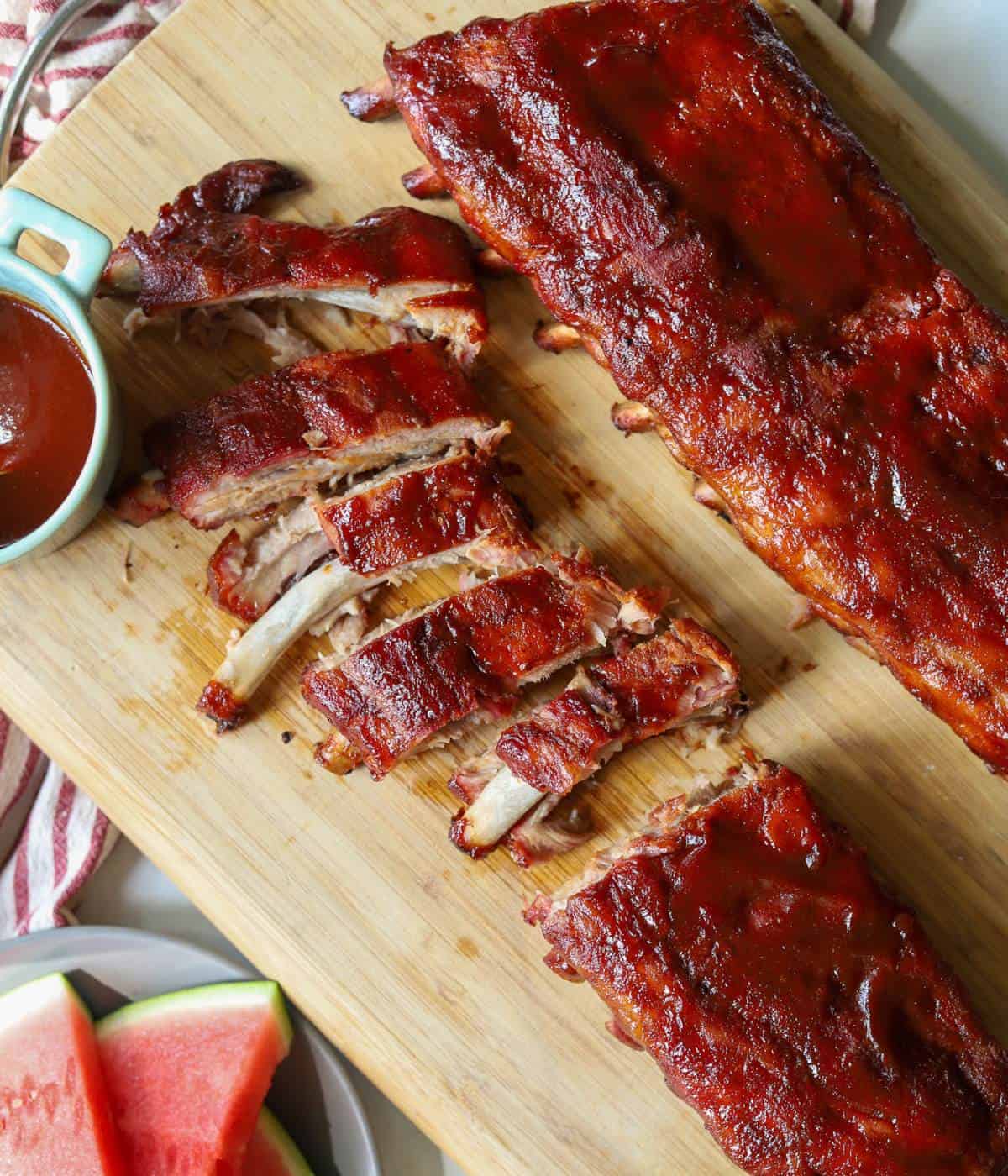 Smoked bbq baby back ribs on cutting board. 