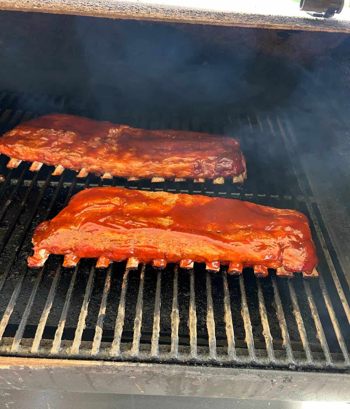 BBQ sauced ribs on the smoker.