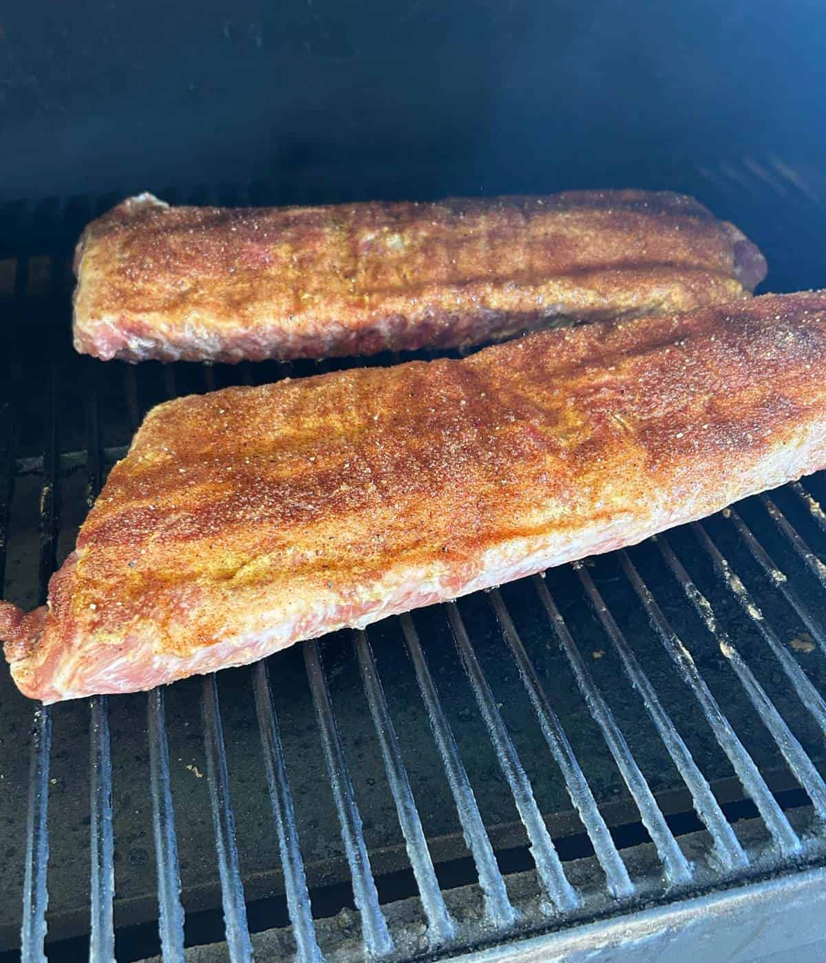 Smoking the ribs in the Traeger with dry rub.