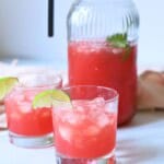 Watermelon water in a pitcher with two glasses.