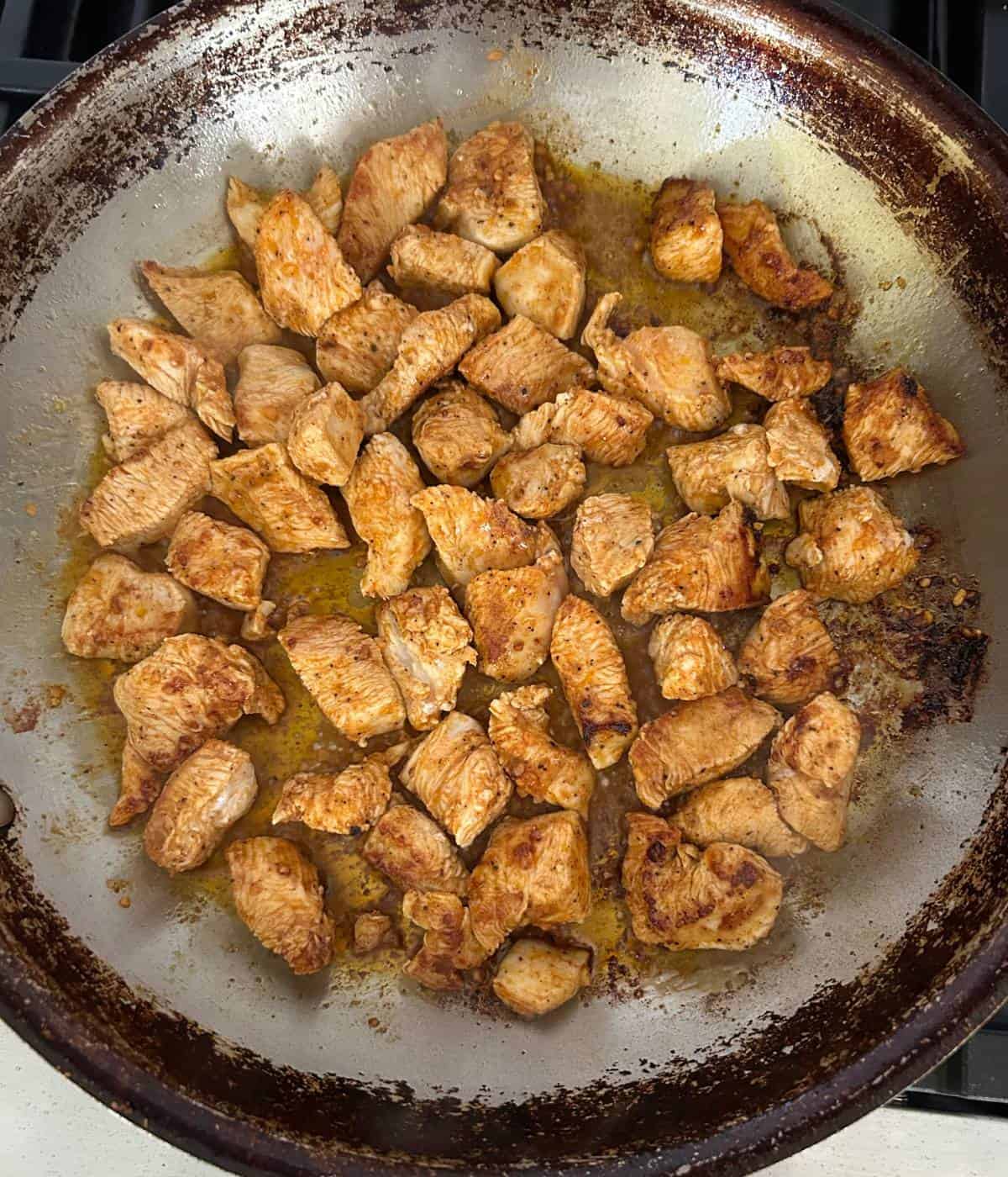 Cooking chicken in skillet.