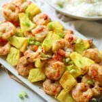 Shrimp kabobs with pineapple on serving dish.