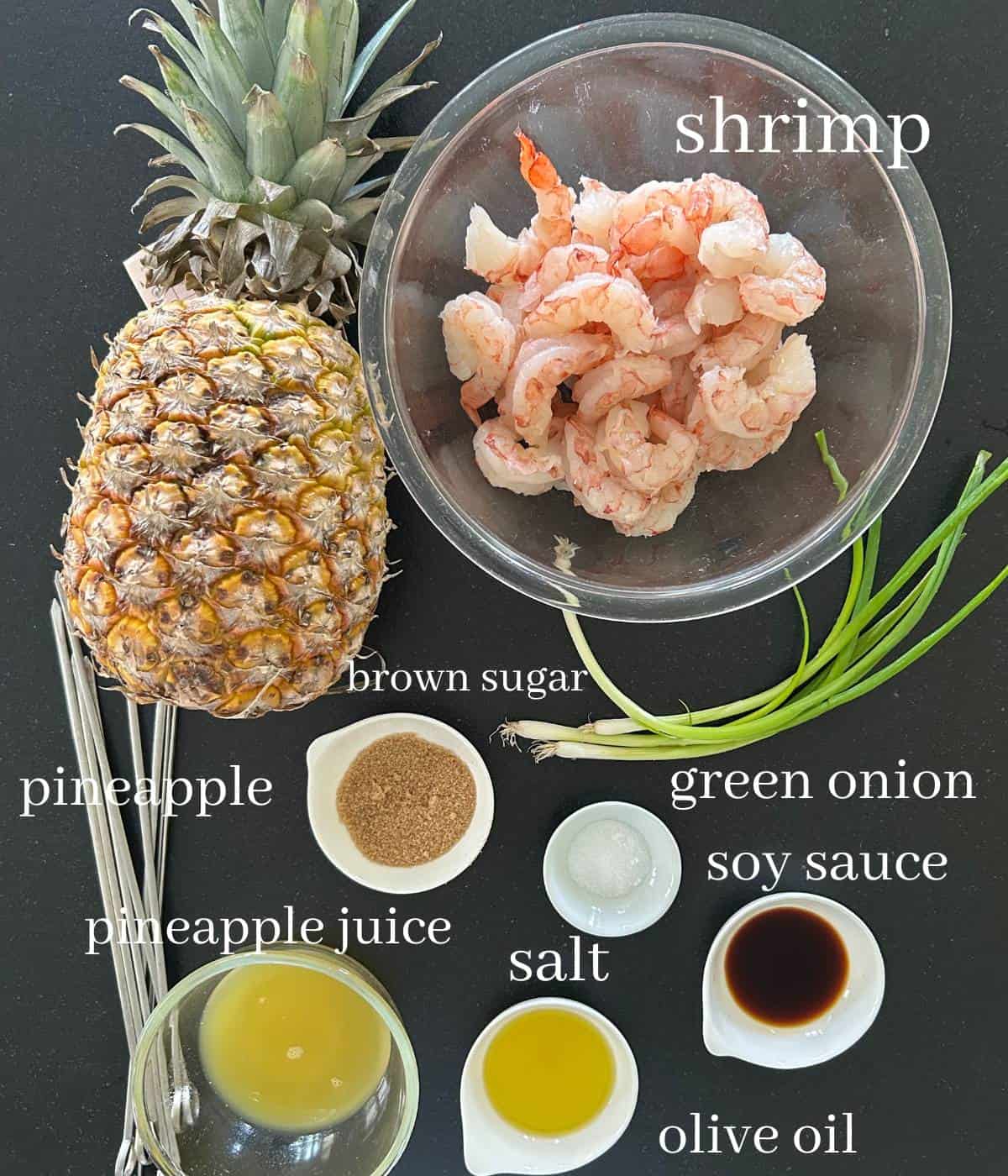 Ingredients for shrimp kabobs on countertop.