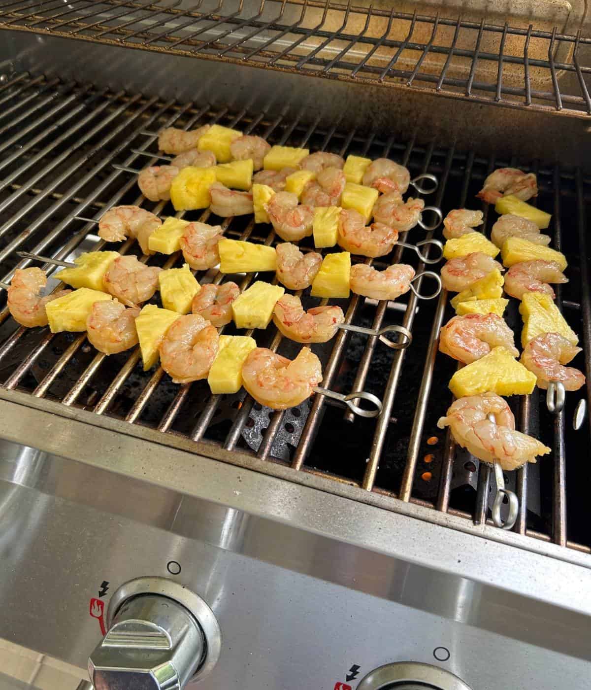 Shrimp skewers on grill.