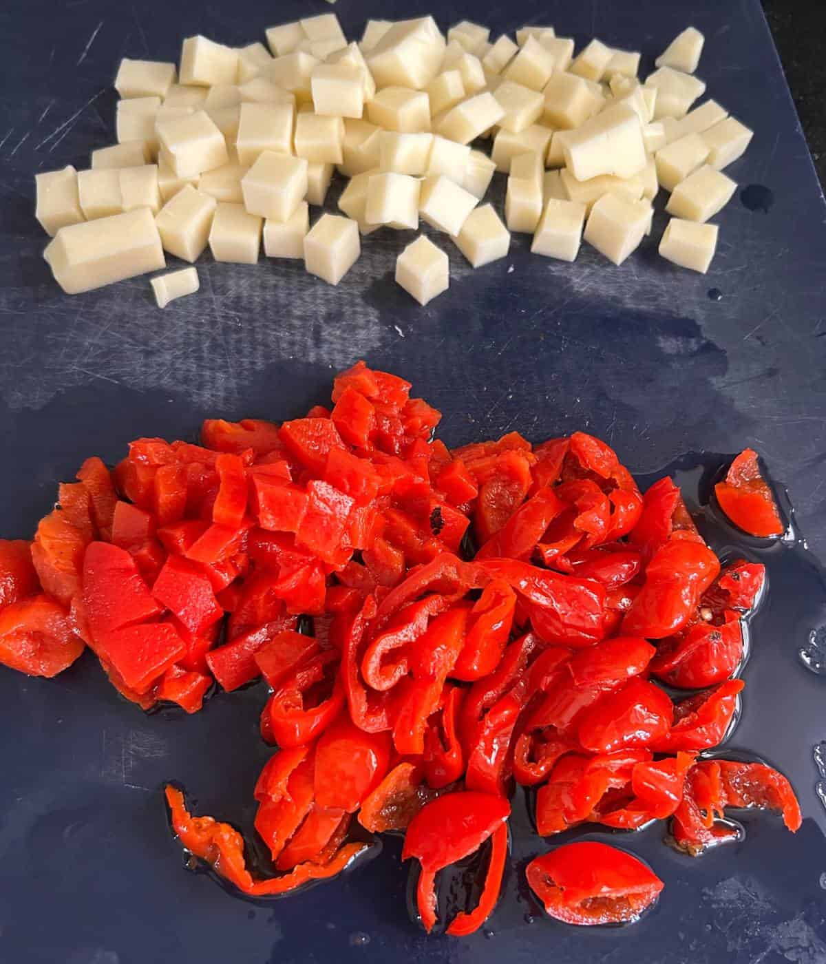 Cut up ingredients for pesto pasta salad.