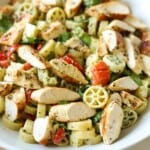 Pesto pasta salad with chicken in bowl.