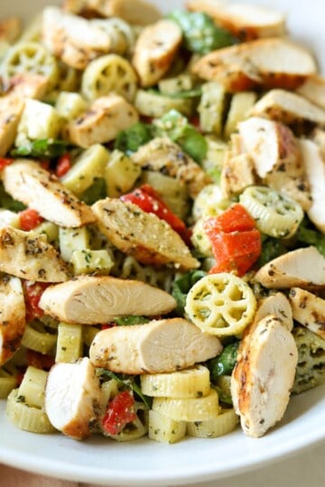 Pesto pasta salad with chicken in bowl.