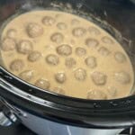Meatballs in sauce in crockpot.
