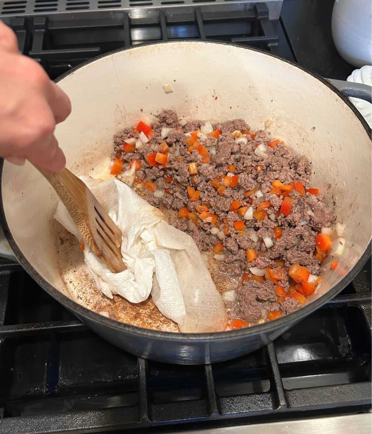 Soaking up grease from pan in dutch oven.