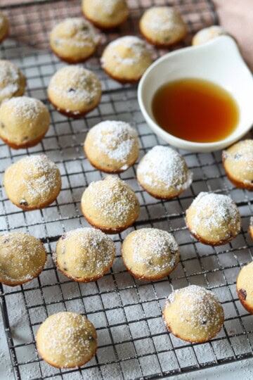 Pancake bites on baking rack topped with powdered sugar.