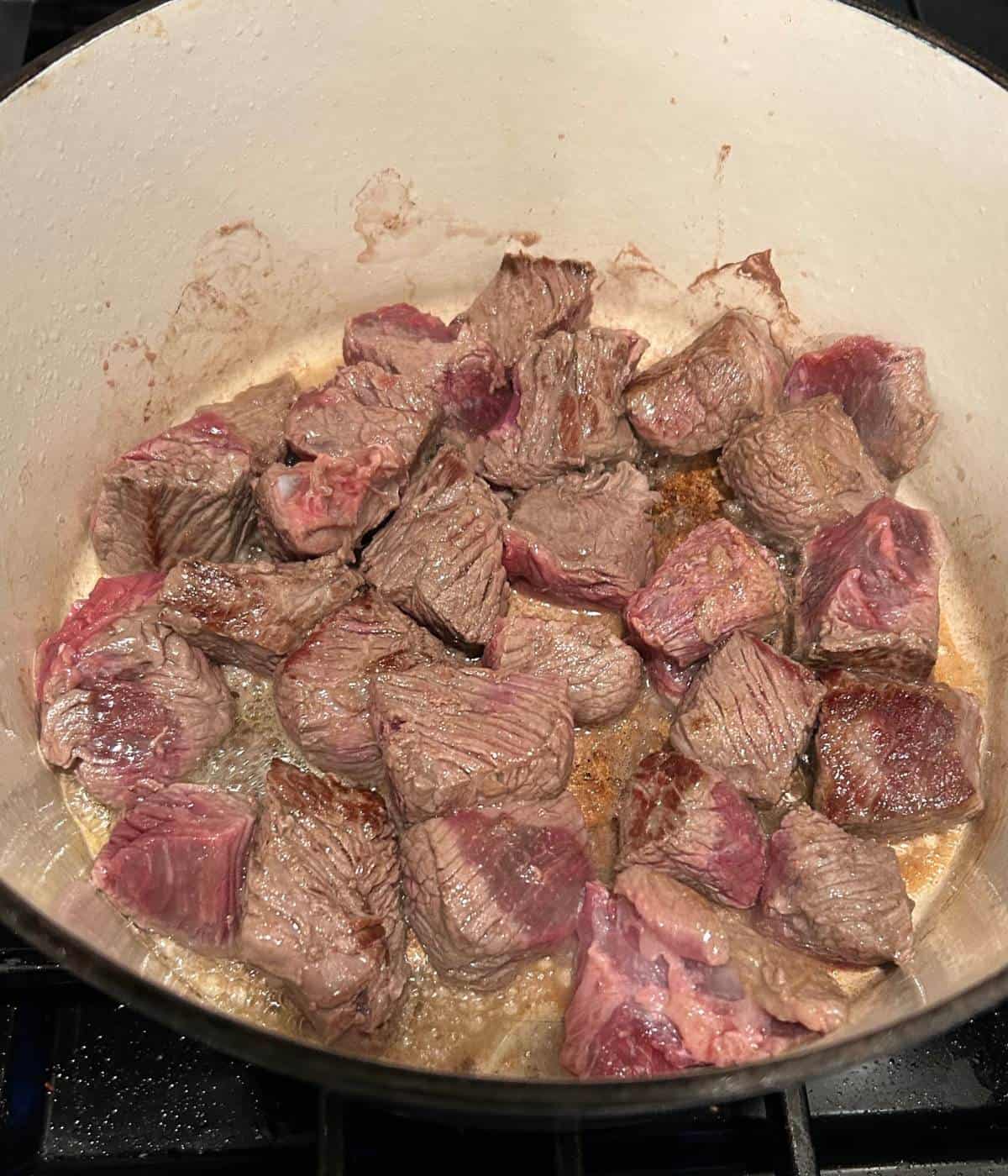 Searing beef in dutch oven.