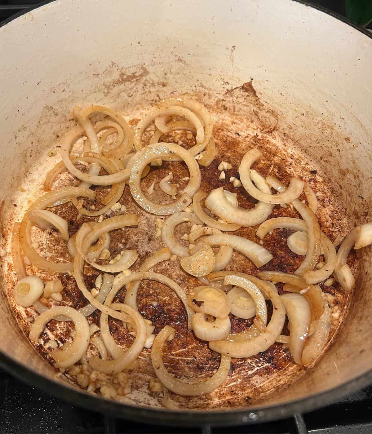 Onions and garlic cooking in dutch oven.