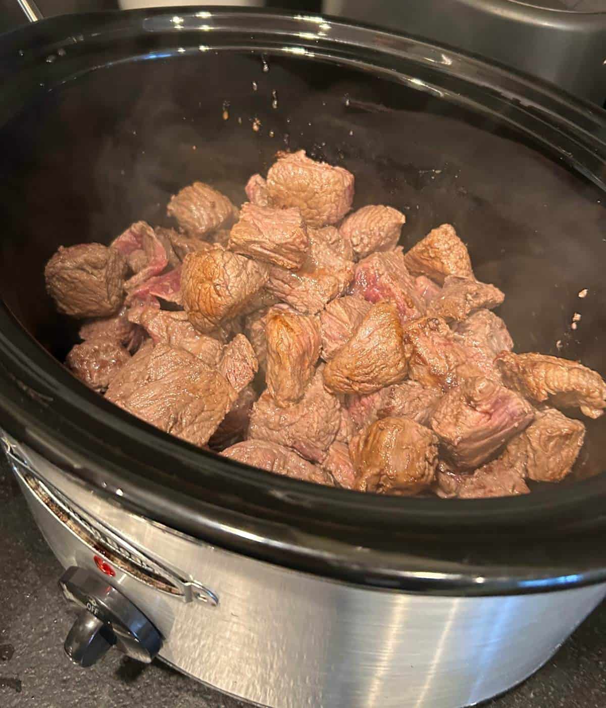 Beef stew meat in crockpot.