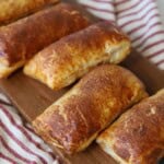 Apple hand pies with puff pastry on serving platter.