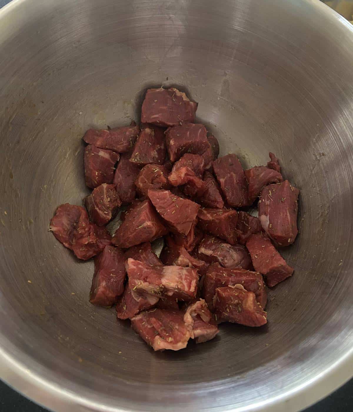 Marinated steak in bowl.