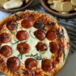 Pepperoni pizza dip topped with basil.