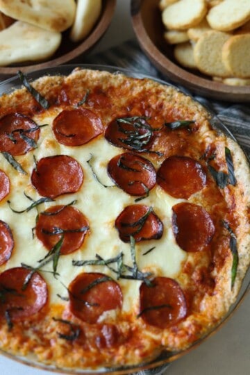 Pepperoni pizza dip topped with basil.