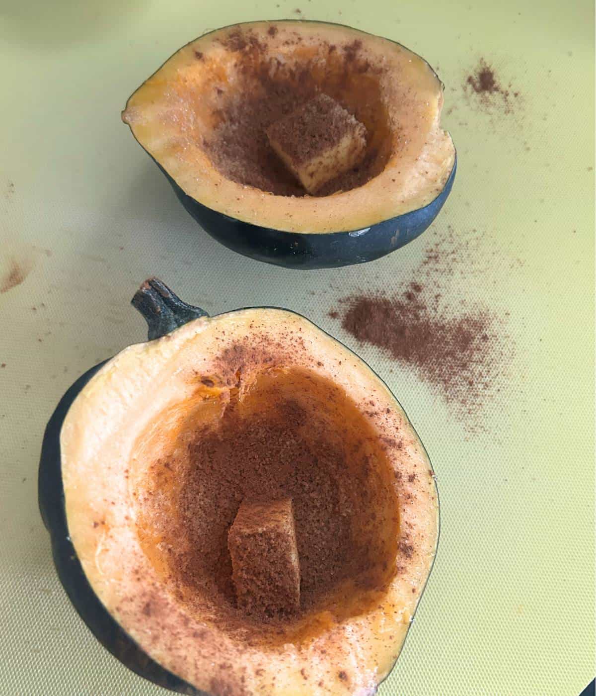 Acorn squash cut in half and filled with butter and cinnamon and sugar.