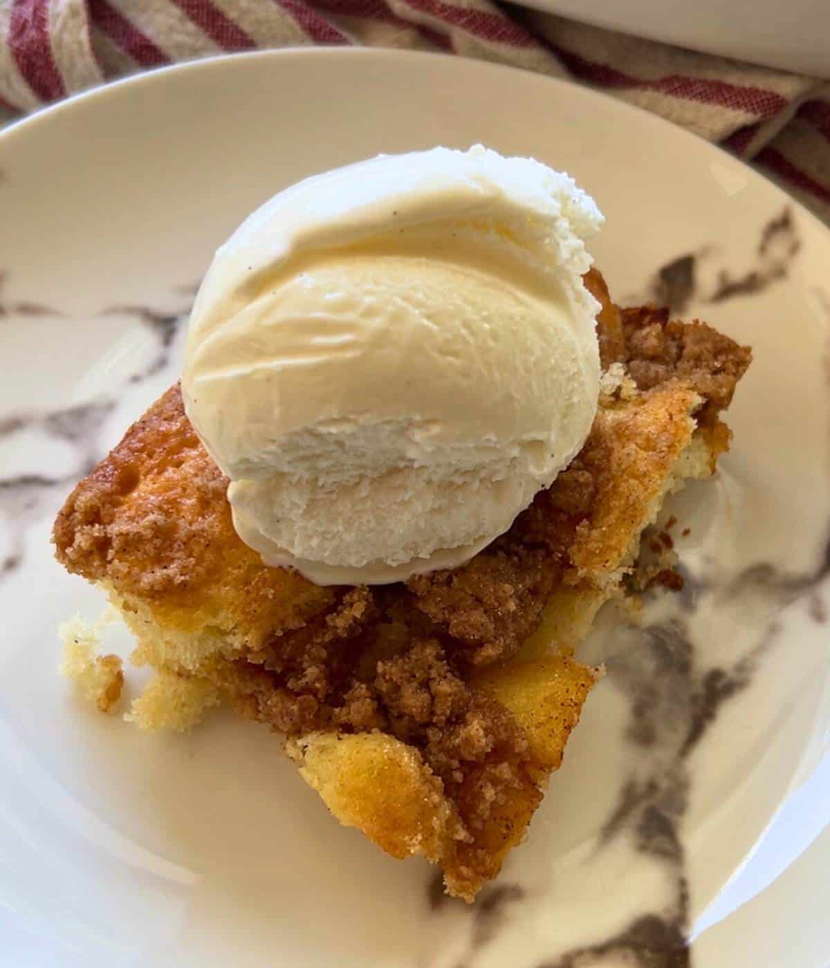 Apple cake with vanilla ice cream on top.