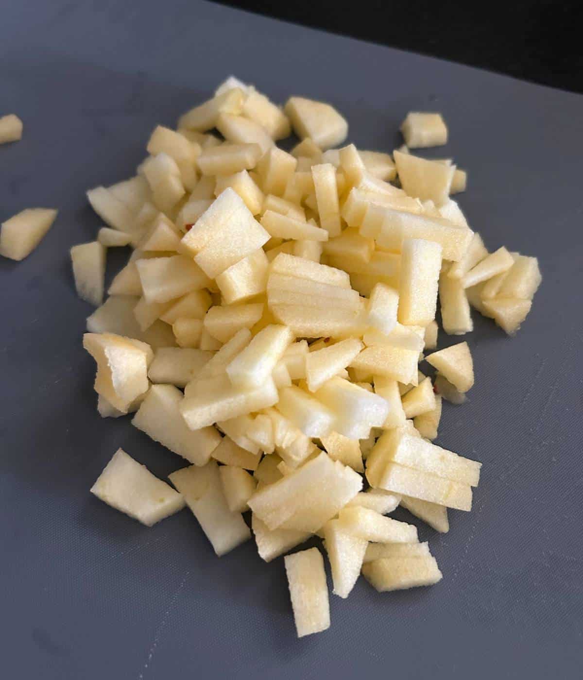 Diced apples on cutting board.