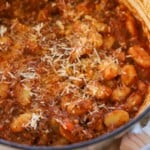 Gnocchi bolognese topped with parmesan.