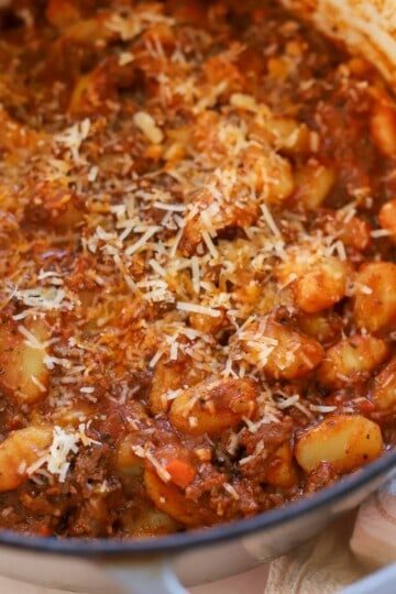 Gnocchi bolognese topped with parmesan.