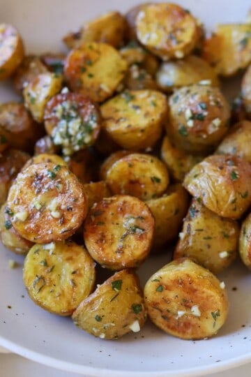 Herb roasted baby potatoes in serving bowl.