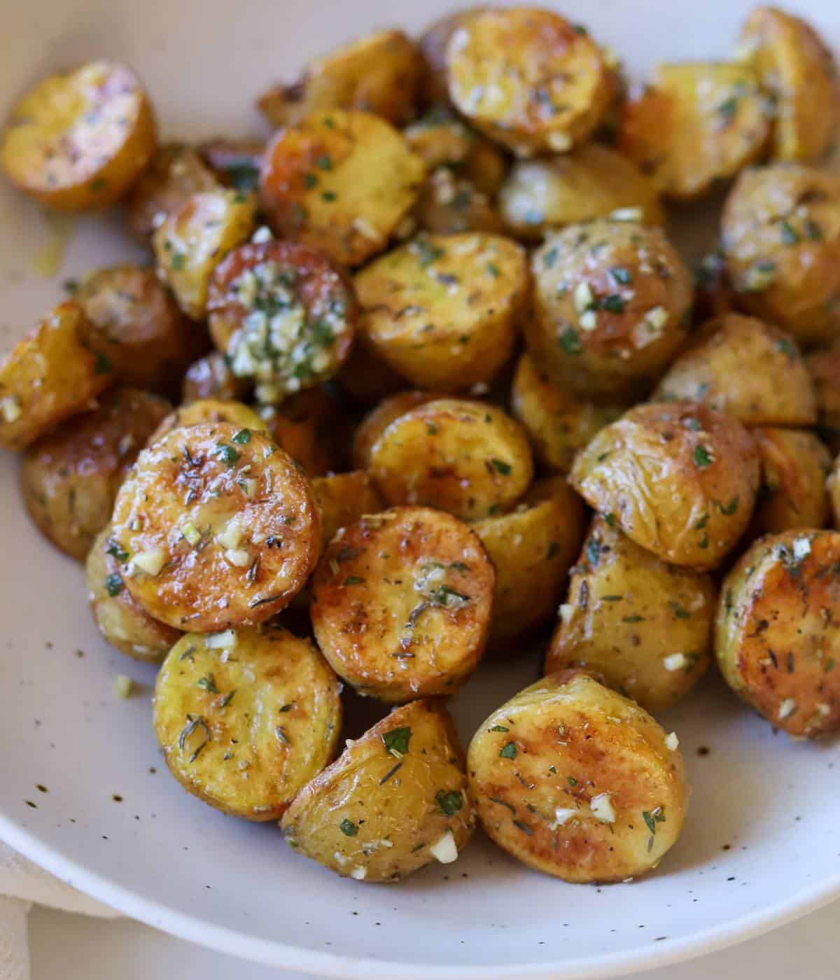Herb roasted baby potatoes in serving bowl. 