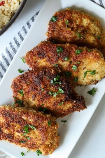 Pan seared pork cutlets on platter.