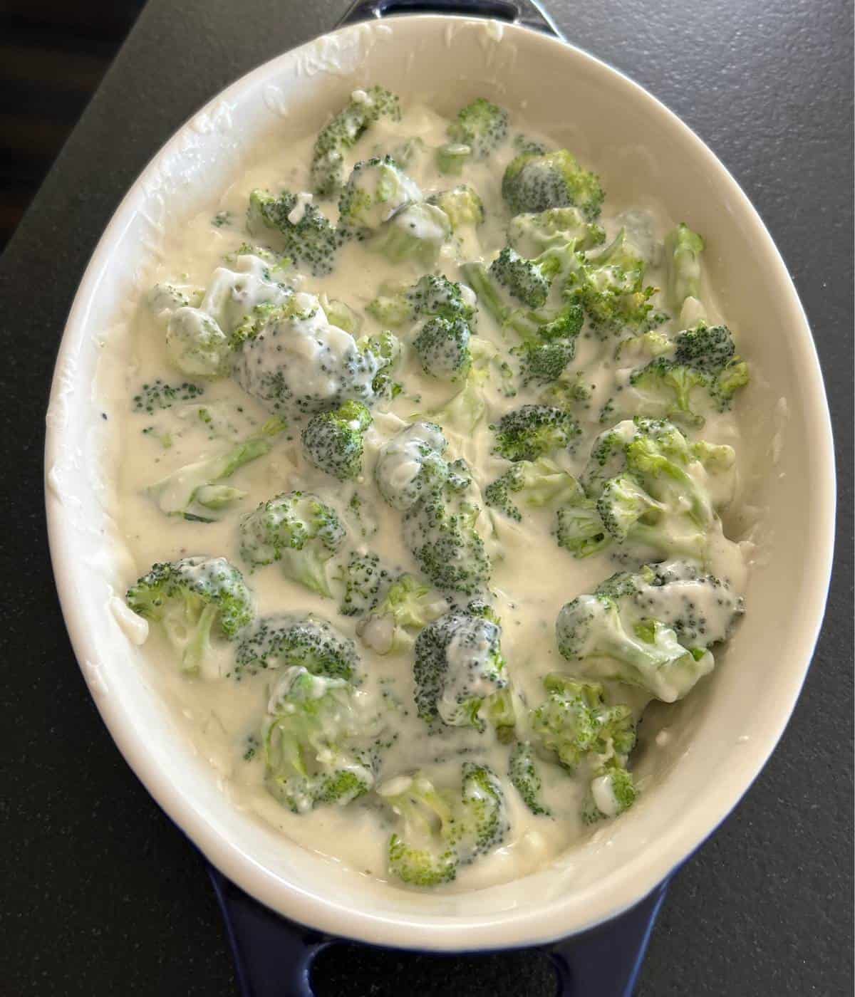 Broccoli and cheese in casserole dish.