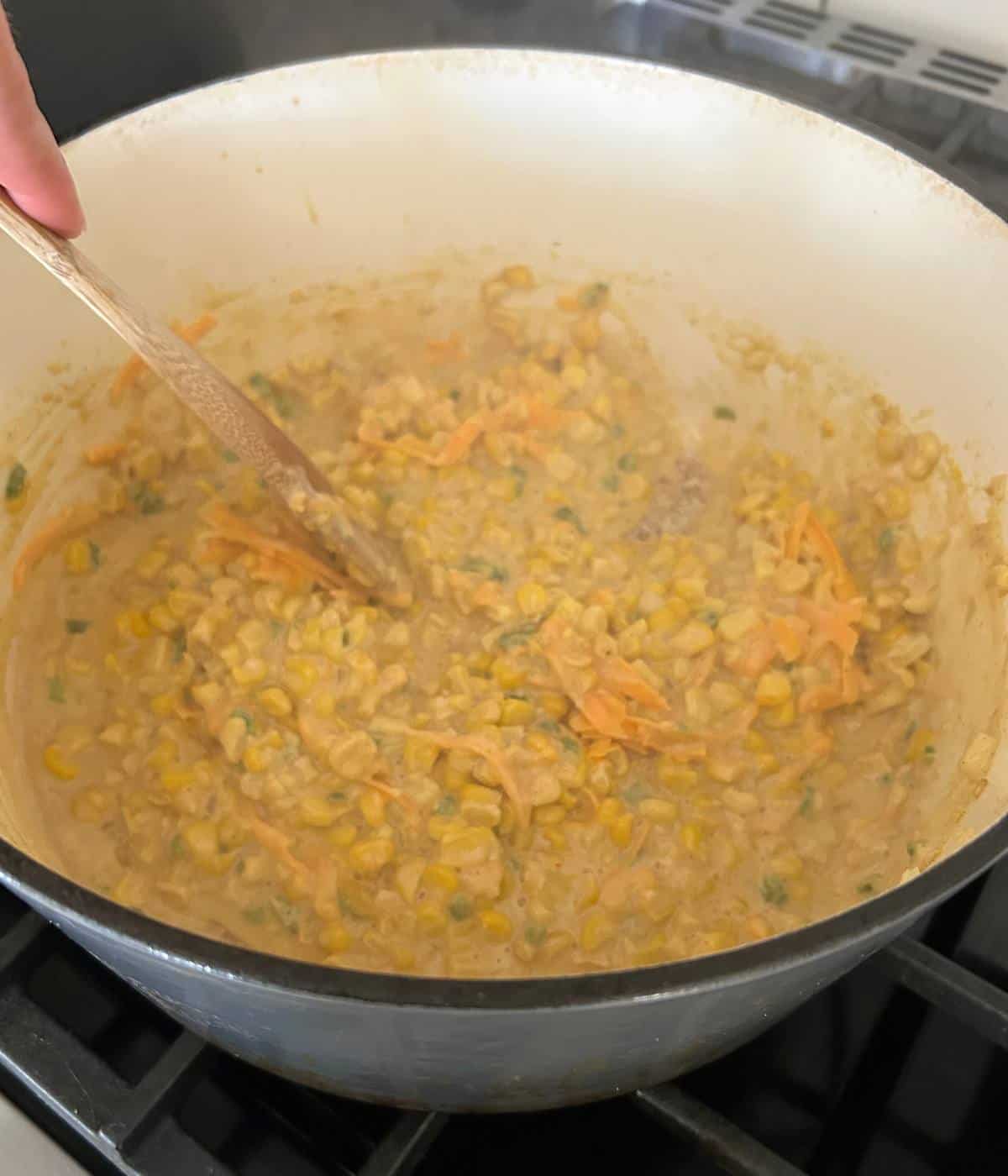 Creamed corn in pot.