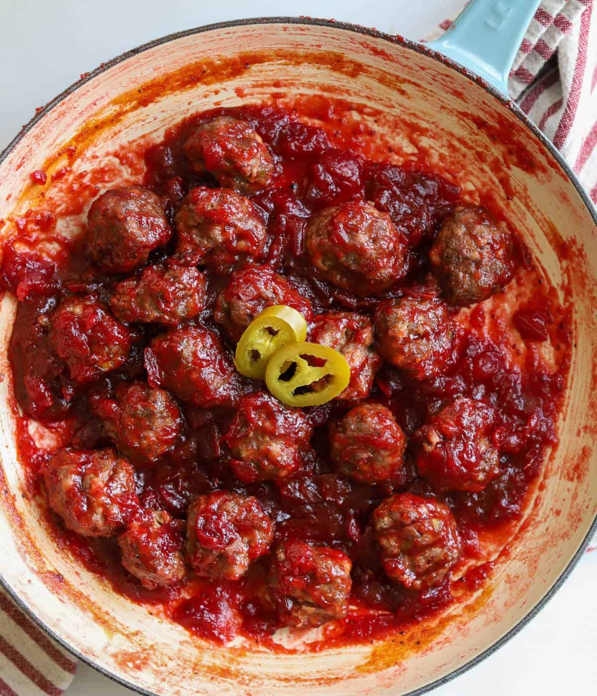 Cranberry meatballs in skillet.
