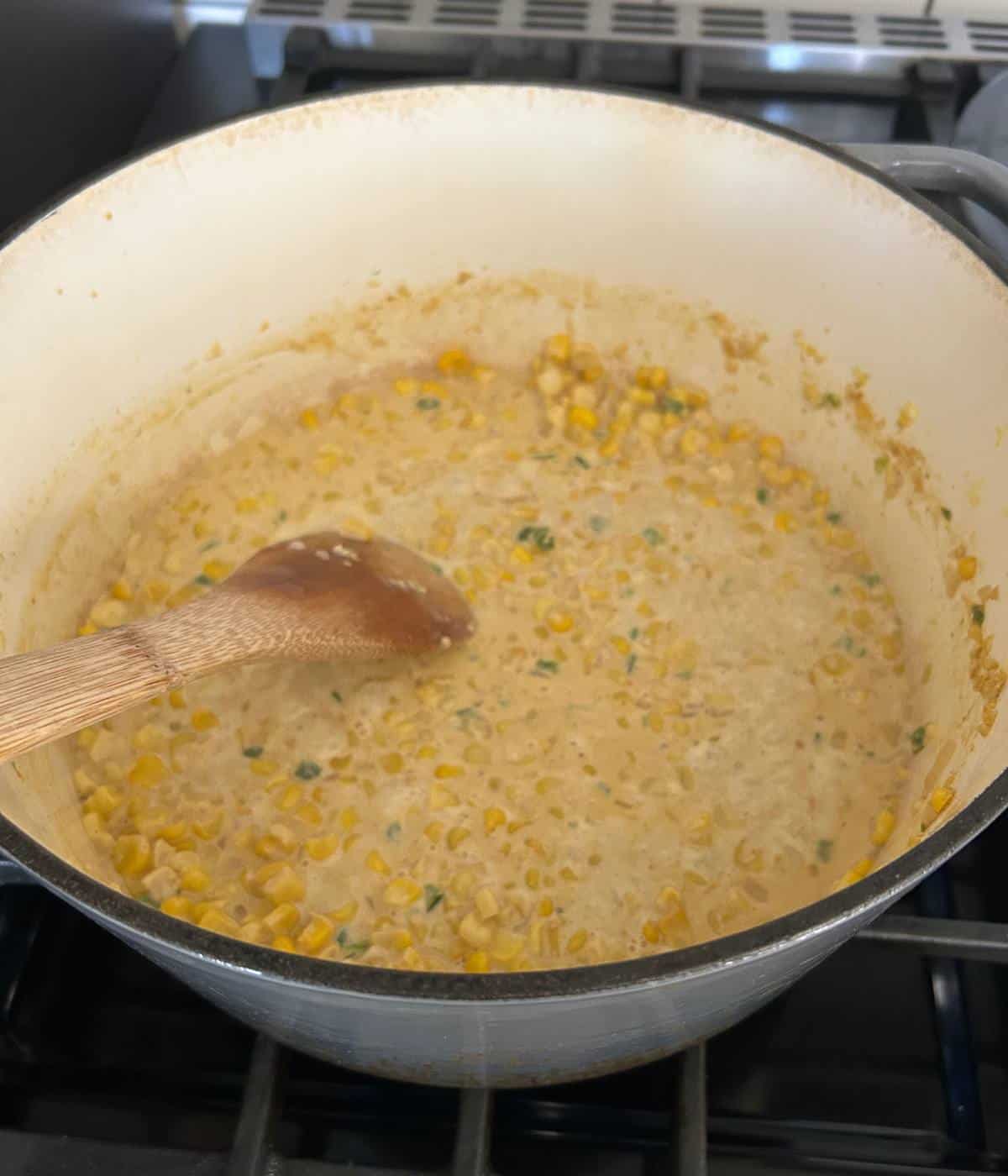 Corn and jalapeños cooking in pot.