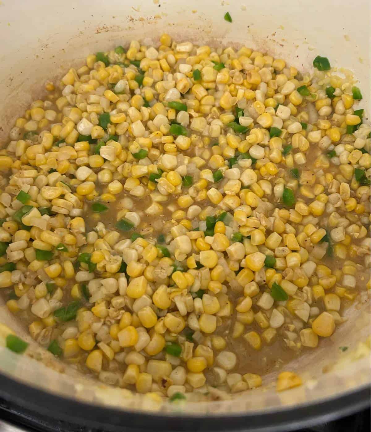 Corn with jalapeños in dutch oven.