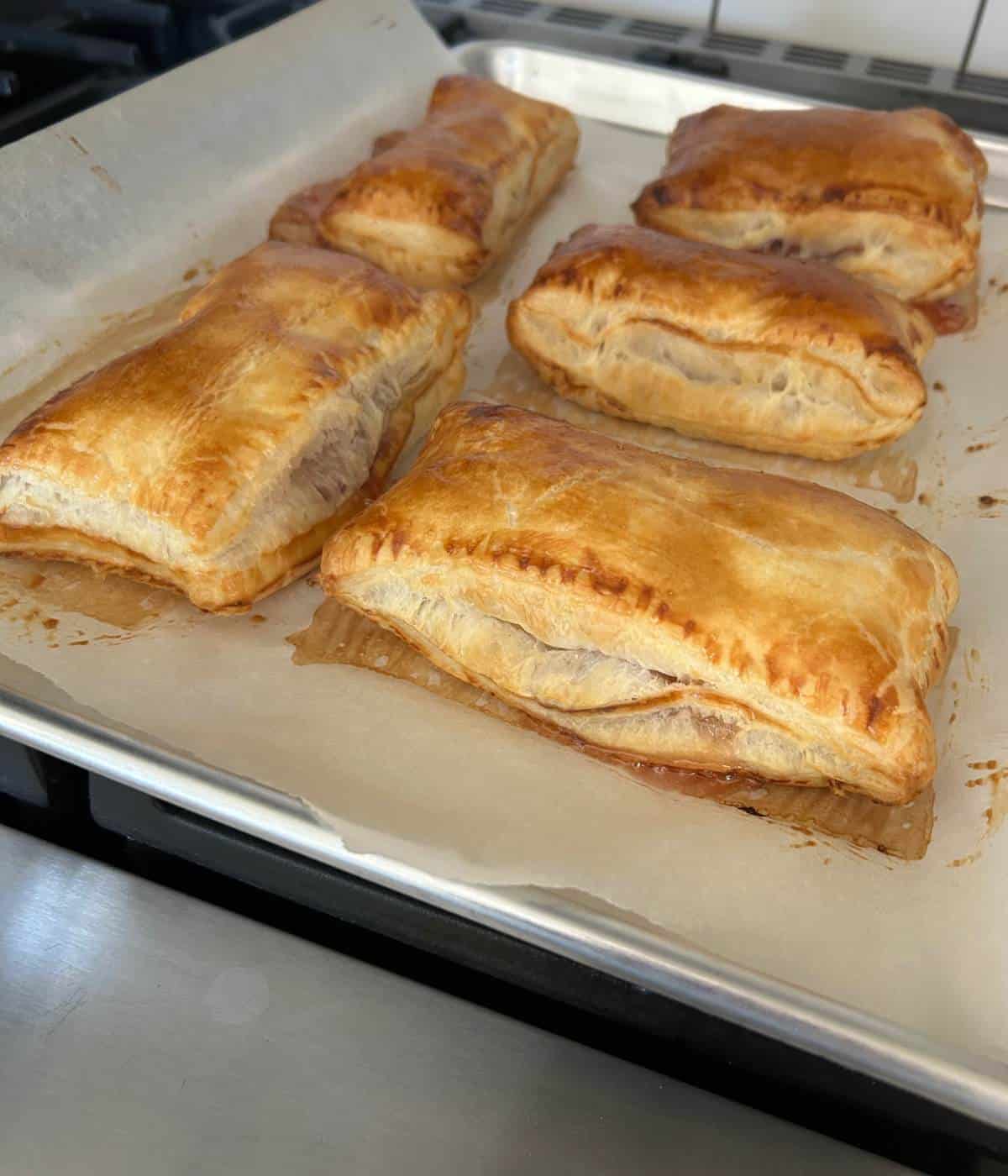 Puff pastry pop tarts on cookie sheet.