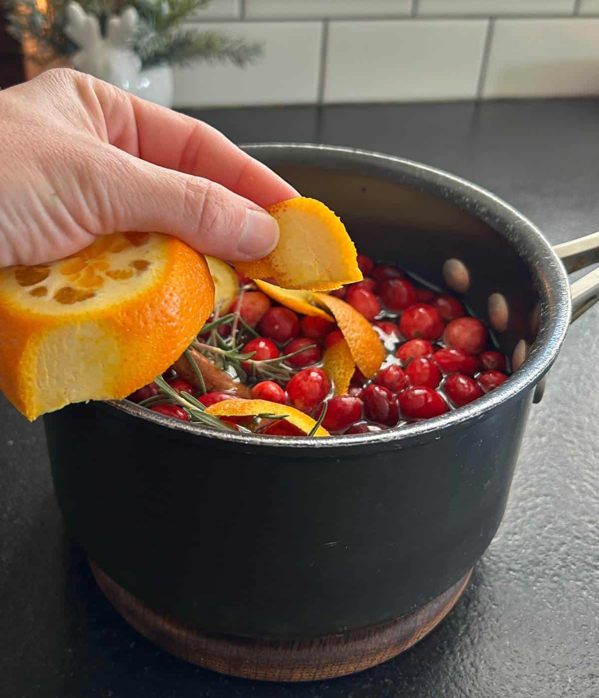 Adding ingredients to the pot.