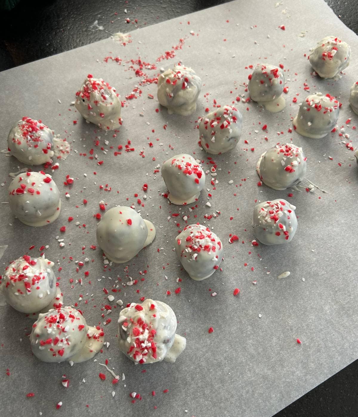 Oreo truffles on parchment paper.