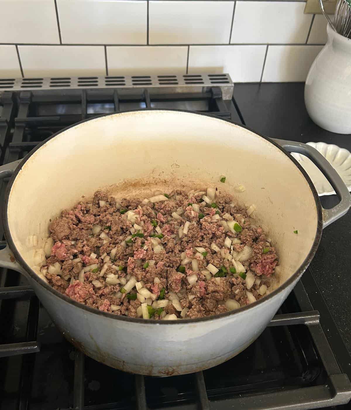 Ground beef, onions and jalapeños in pot.